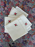 Four napkins with rose detail