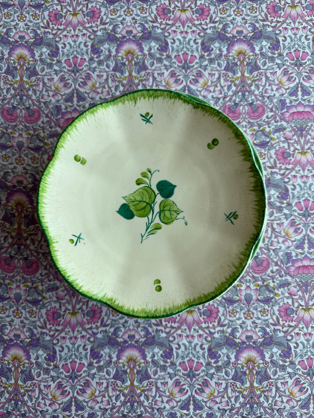 Four green hand painted plates