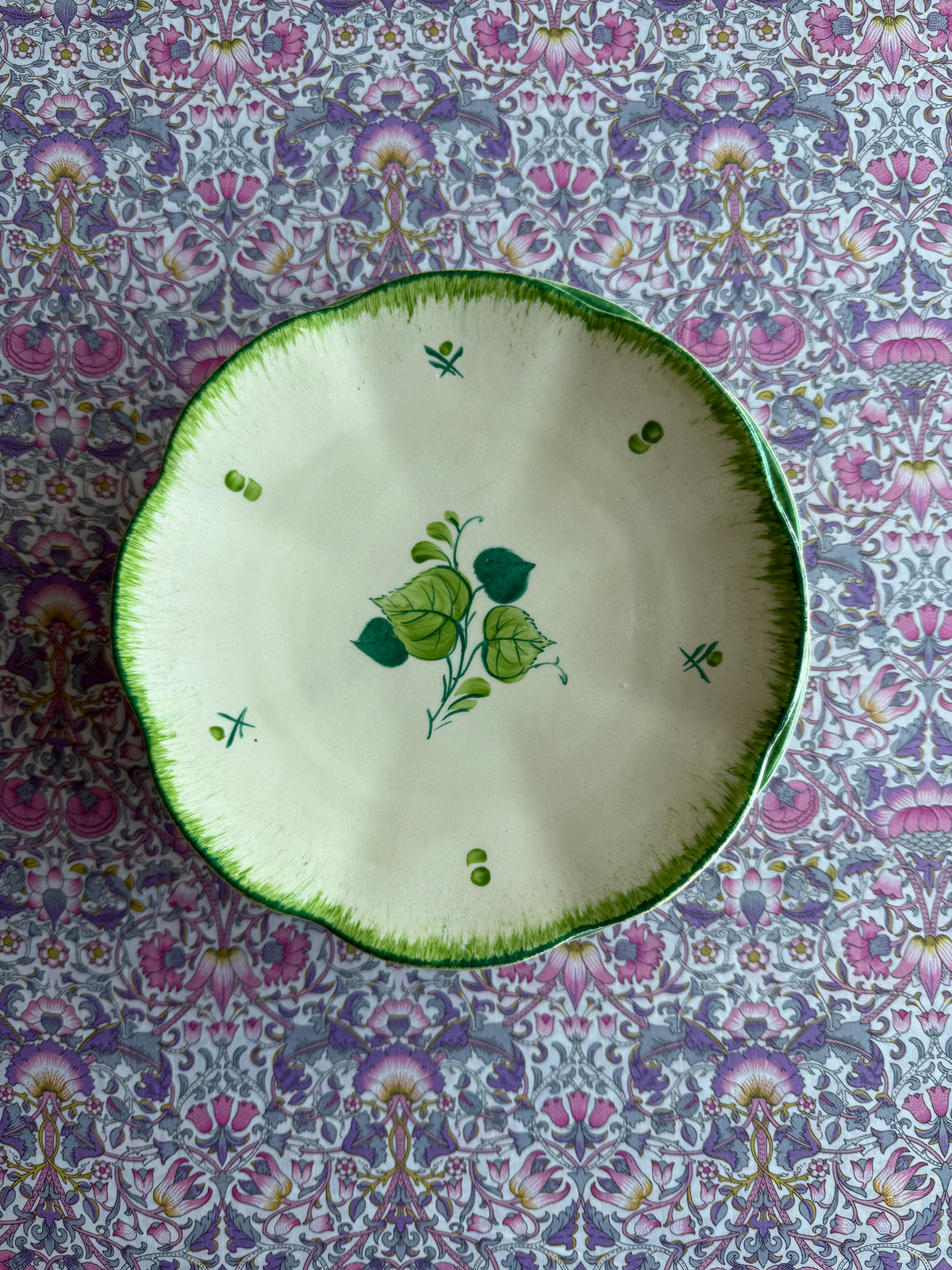 Four green hand painted plates